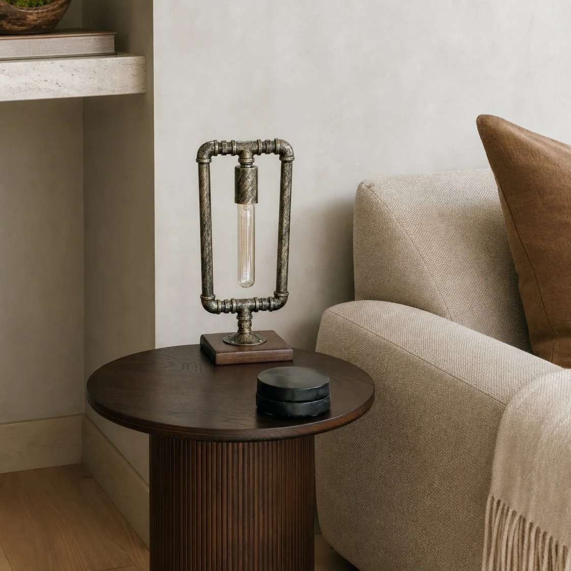 Industrial pipe table lamp on a round side table